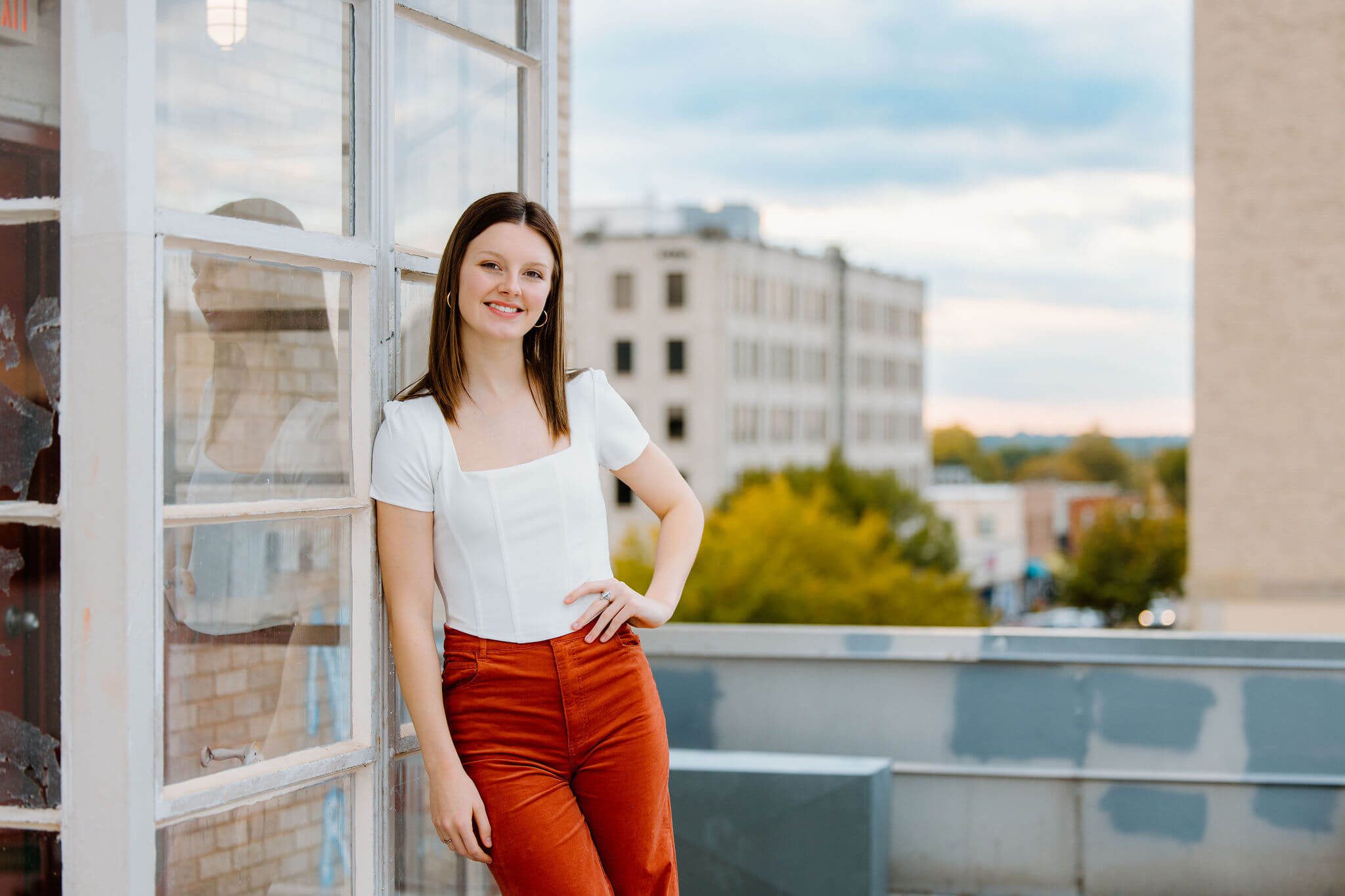senior photograph of 2023 graduate on downtown East Texas rooftop