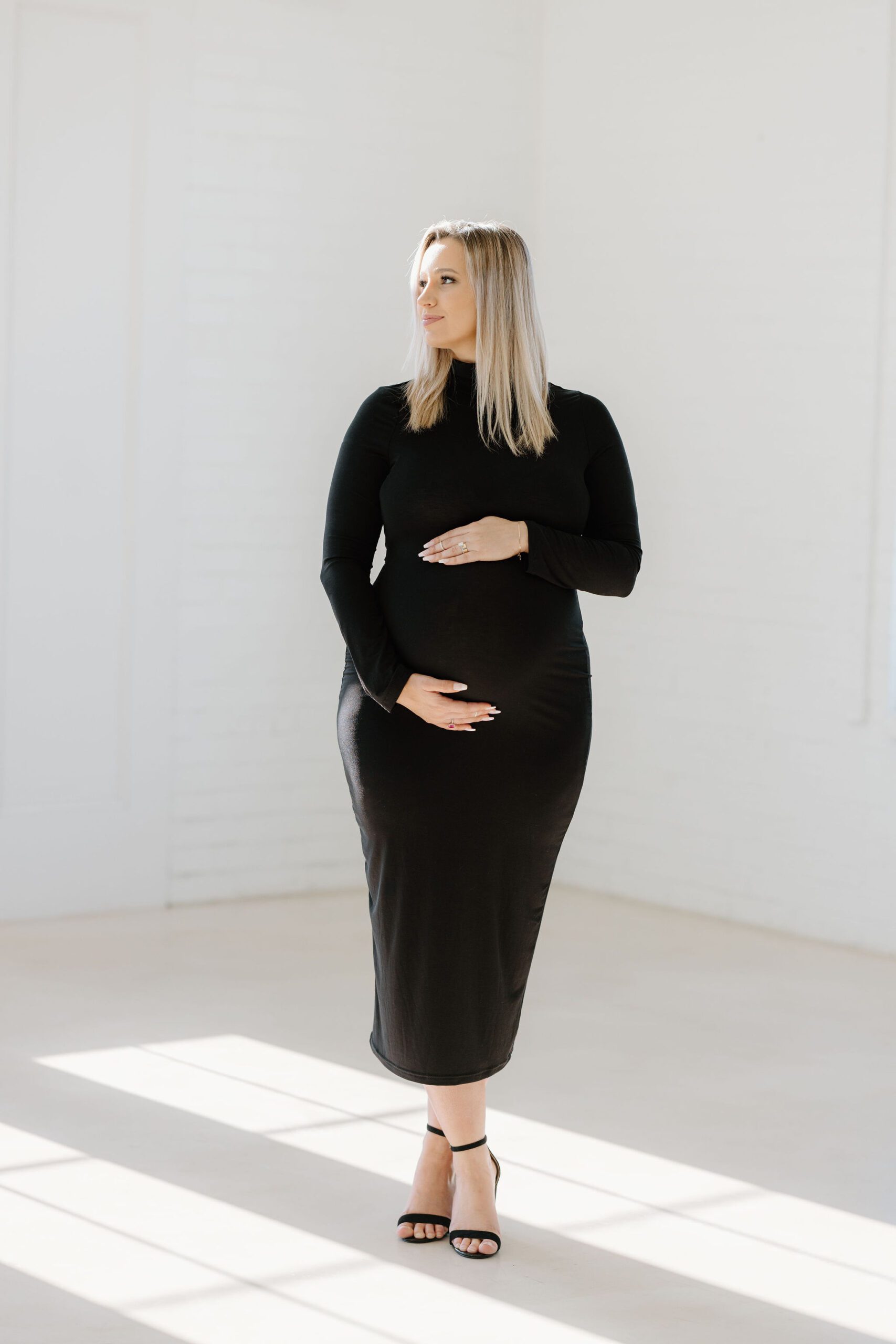 maternity picture of expecting mother in long black dress