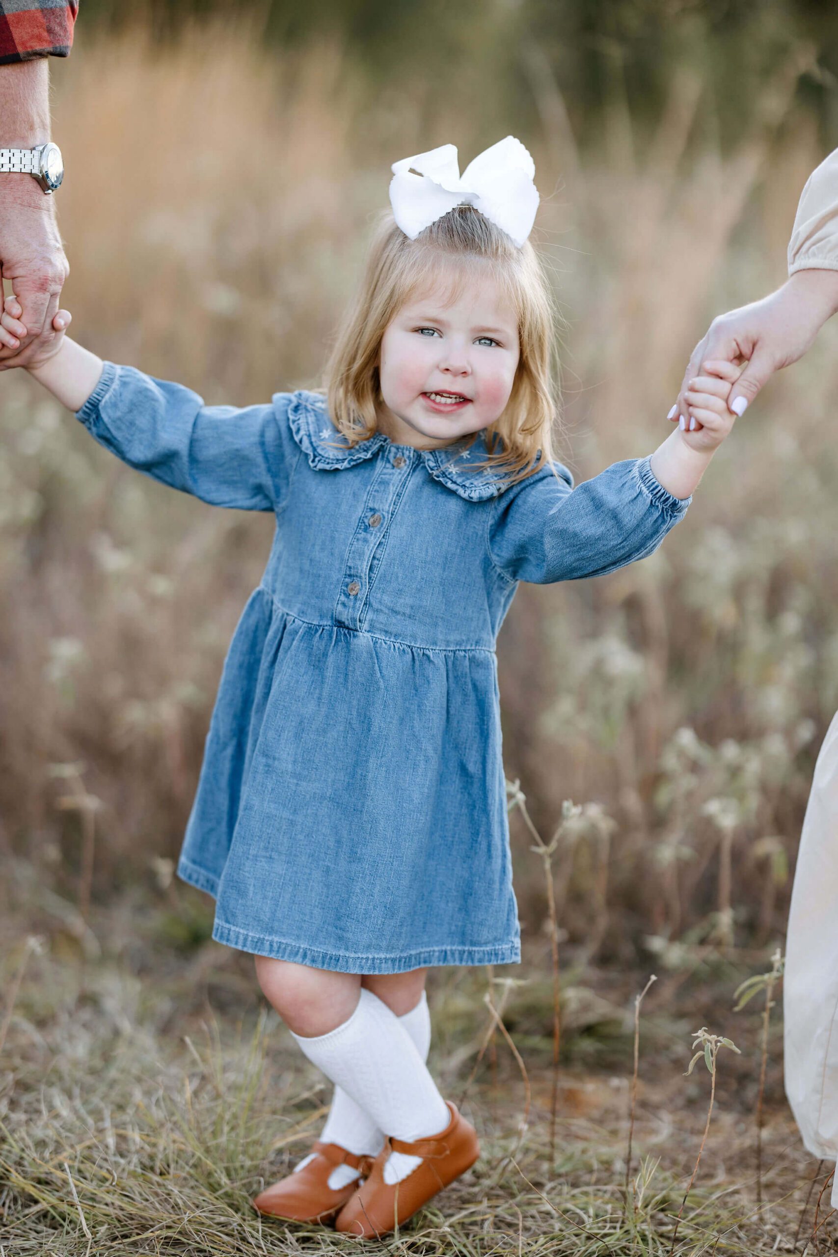 Young girl in a blue dress during an outdoor family photography session in East Texas