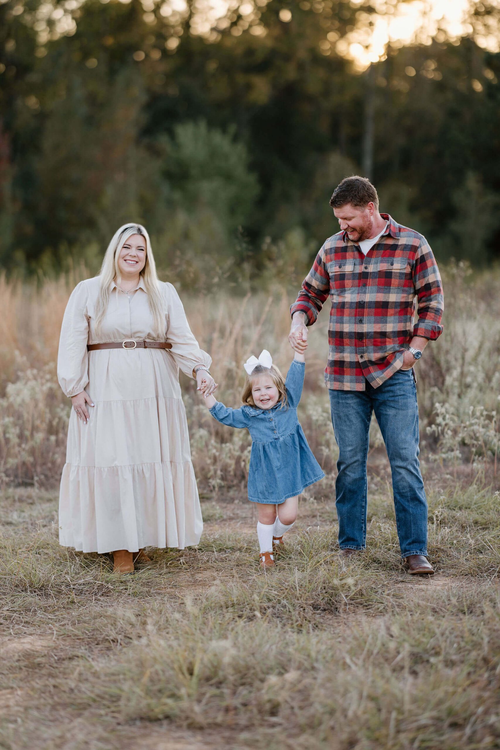 Family walking together in coordinated neutral outfits during an East Texas family photography session